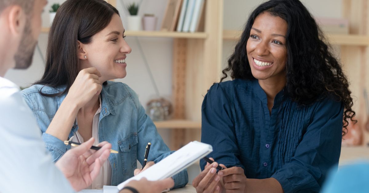 two young women at a meeting