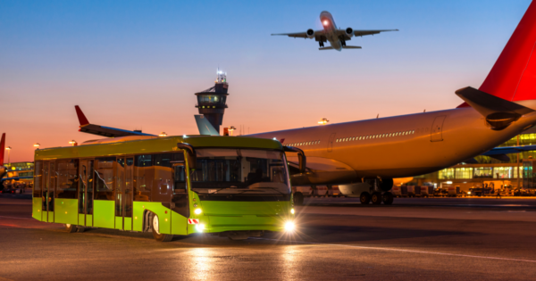 bus at an airport with airplanes