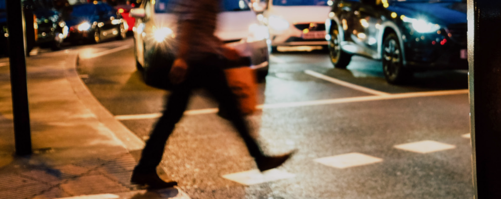 blur style photo of person entering a city crosswalk