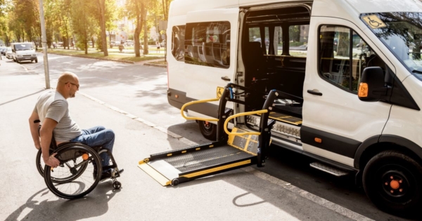 a wheelchair using about to board a paratransit bus
