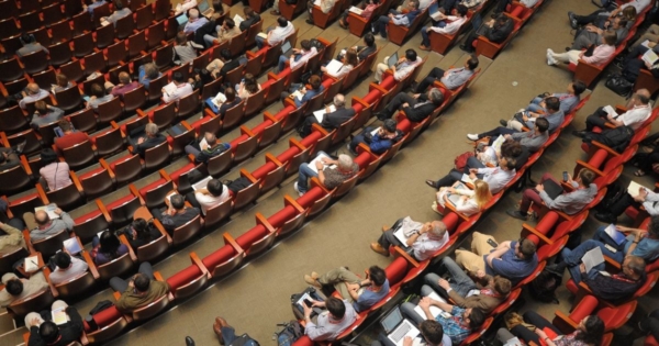 an aerial view of the audience at a conference
