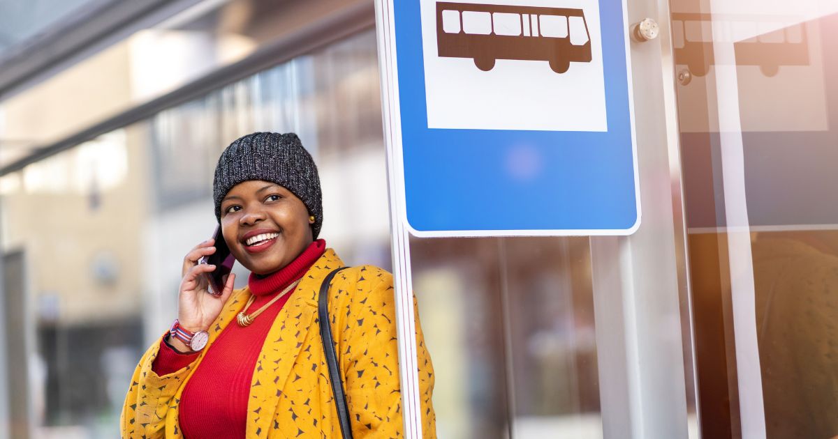 smiling woman waiting for her bus
